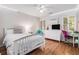 Bedroom with a ceiling fan, bright windows, and hardwood floors at 1600 Heritage Trl, Roswell, GA 30075