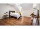 Bedroom with wood floors, neutral walls and a bed with white comforter at 1600 Heritage Trl, Roswell, GA 30075