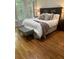 Cozy bedroom with hardwood floors, neutral decor, large windows, and custom window shutters at 1600 Heritage Trl, Roswell, GA 30075
