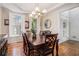 Elegant dining room with hardwood floors, modern lighting fixture, and detailed trim at 1600 Heritage Trl, Roswell, GA 30075