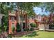 Charming two-story brick home featuring an attached two-car garage and beautiful landscaping at 1600 Heritage Trl, Roswell, GA 30075
