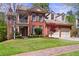 Beautiful brick two-story home with dormer windows and attached two car garage at 1600 Heritage Trl, Roswell, GA 30075
