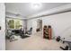 Bright home gym with exercise equipment and natural light from large windows at 1600 Heritage Trl, Roswell, GA 30075