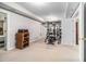 Home gym with weightlifting equipment and a storage cabinet for organization at 1600 Heritage Trl, Roswell, GA 30075