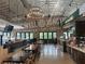 This is an interior of the restaurant with a bar, tables, chairs, and large sign on the wall at 1600 Heritage Trl, Roswell, GA 30075