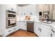 Modern kitchen features white cabinets, subway tile backsplash, stainless steel appliances, and light countertops at 1600 Heritage Trl, Roswell, GA 30075