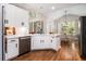 Bright, updated kitchen with white cabinets, hardwood floors, stainless steel appliances and natural light at 1600 Heritage Trl, Roswell, GA 30075