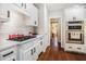 Stylish kitchen with white cabinets, subway tile, stainless appliances, gas cooktop and hardwood floors at 1600 Heritage Trl, Roswell, GA 30075