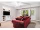 Cozy living room featuring a built-in entertainment center and a comfortable red sofa at 1600 Heritage Trl, Roswell, GA 30075