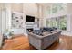 Spacious living room with hardwood floors, fireplace, built-in cabinets, and large windows with views at 1600 Heritage Trl, Roswell, GA 30075