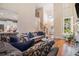 Beautiful living room featuring tall ceilings, hardwood floors, fireplace, and an open concept floorplan at 1600 Heritage Trl, Roswell, GA 30075