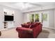Comfortable living room with a large sofa, built-in shelves, and a door to the exterior at 1600 Heritage Trl, Roswell, GA 30075