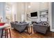 Bright living room featuring high ceilings, fireplace, custom built-ins, hardwood floors, and plenty of natural light at 1600 Heritage Trl, Roswell, GA 30075