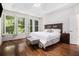 Serene main bedroom with tray ceilings, natural light, and hardwood floors at 1600 Heritage Trl, Roswell, GA 30075