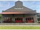 Roswell Junction: Brick building with red awnings offers counter-tap-social experience, highlighted by outdoor seating at 1600 Heritage Trl, Roswell, GA 30075