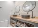 Bathroom featuring dual vessel sinks, wood countertop, and open shelving at 188 Cooper Creek Dr, Dallas, GA 30157