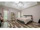 Spacious bedroom with tray ceilings, stylish decor, and natural light from large windows at 188 Cooper Creek Dr, Dallas, GA 30157