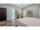 Large bedroom featuring hardwood floors and access to bathroom, illuminated by natural light at 188 Cooper Creek Dr, Dallas, GA 30157