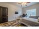 Bedroom with ceiling fan, wood-look floors, TV, and natural light at 188 Cooper Creek Dr, Dallas, GA 30157