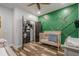 Bedroom showcases green accent wall, wooden crib, closet, and modern décor for a cozy feel at 188 Cooper Creek Dr, Dallas, GA 30157