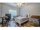 Cozy bedroom with a ceiling fan, wood-look floors, and natural light at 188 Cooper Creek Dr, Dallas, GA 30157