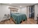 Cozy bedroom with wood look floors, closet, and bright white shiplap walls at 188 Cooper Creek Dr, Dallas, GA 30157