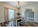 Dining room features modern chandelier, table with benches, and view to a stylish decorated room at 188 Cooper Creek Dr, Dallas, GA 30157