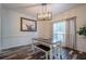 Elegant dining area with modern chandelier, table with benches, and large window with lots of light at 188 Cooper Creek Dr, Dallas, GA 30157