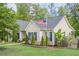 A cozy single-Gathering home showcasing blue shutters, a well-kept lawn, and an American flag at 188 Cooper Creek Dr, Dallas, GA 30157