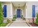 Inviting entryway with blue front door, stone accents, and well-kept landscaping, offering a warm welcome at 188 Cooper Creek Dr, Dallas, GA 30157