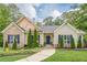 Charming home featuring a stone facade, manicured lawn, and a welcoming walkway, and eye-catching blue shutters at 188 Cooper Creek Dr, Dallas, GA 30157