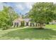 Spacious front yard with mature tree and well-maintained lawn, showcasing the home's curb appeal and serene setting at 188 Cooper Creek Dr, Dallas, GA 30157