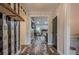 Stylish hallway featuring unique accent wall, wood-look floors, and views into the adjacent living space at 188 Cooper Creek Dr, Dallas, GA 30157