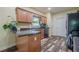 Well-lit kitchen features wood cabinets, dark countertops, and sleek black appliances adding charm at 188 Cooper Creek Dr, Dallas, GA 30157