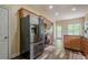 Bright kitchen with stainless steel fridge, wood cabinets, and a back door allowing abundant natural light at 188 Cooper Creek Dr, Dallas, GA 30157