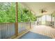 Covered porch featuring a decorative railing and an outdoor rug at 188 Cooper Creek Dr, Dallas, GA 30157