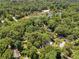 Aerial view of the home and surrounding community with a lake in the distance at 4649 Dahlia Dr, Pine Lake, GA 30072