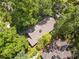 Aerial view of the home, with a mature tree canopy at 4649 Dahlia Dr, Pine Lake, GA 30072