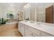 Bathroom boasts double sinks, soaking tub, tiled floors, and natural light from a window at 4649 Dahlia Dr, Pine Lake, GA 30072