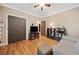 Cozy bedroom with hardwood floors, ceiling fan, and ample space at 4649 Dahlia Dr, Pine Lake, GA 30072