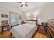 Comfortable bedroom featuring hardwood floors and natural light at 4649 Dahlia Dr, Pine Lake, GA 30072