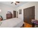 Bedroom features wood floors, ceiling fan, and closet space at 4649 Dahlia Dr, Pine Lake, GA 30072