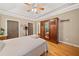Bright bedroom featuring hardwood floors, tray ceiling, and large closet space at 4649 Dahlia Dr, Pine Lake, GA 30072