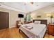 Cozy bedroom with wood floors, tray ceilings, and a view to outside greenery at 4649 Dahlia Dr, Pine Lake, GA 30072
