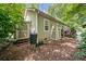 Outside view of the home, featuring two outdoor storage units and a deck with outdoor seating at 4649 Dahlia Dr, Pine Lake, GA 30072