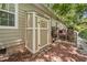 View of the exterior of the home, showing an outdoor shower, a deck, and a wooded yard at 4649 Dahlia Dr, Pine Lake, GA 30072