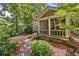 Quaint home featuring a lovely screened porch surrounded by mature trees and greenery at 4649 Dahlia Dr, Pine Lake, GA 30072