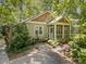 Attractive home exterior with a screened porch and lush landscaping in a wooded setting at 4649 Dahlia Dr, Pine Lake, GA 30072
