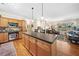 A kitchen featuring an island with seating, stainless steel appliances, and an open floor plan at 4649 Dahlia Dr, Pine Lake, GA 30072