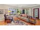 Comfortable living room with hardwood floors, a classic rug, and ample natural light at 4649 Dahlia Dr, Pine Lake, GA 30072